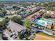 Aerial view of a residential area showcasing the pool, tennis court, and lush landscaping at 3206 Sabal Palms Ct # A, Kissimmee, FL 34747