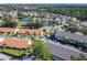 An aerial view of the community showing winding streets, mature trees and a pond at 3206 Sabal Palms Ct # A, Kissimmee, FL 34747