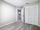 Bedroom featuring wood look floors, closet, and neutral paint at 3206 Sabal Palms Ct # A, Kissimmee, FL 34747