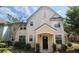 Charming two-story townhome showcasing a black front door and manicured landscaping at 3364 Westchester Square Blvd # 104, Orlando, FL 32835