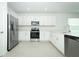 Well-lit kitchen featuring stainless steel appliances and sleek white cabinetry at 338 Wayland Dr, Haines City, FL 33844