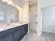 Modern bathroom showcasing double sinks, shower with glass door at 340 Bahia Cir, Longwood, FL 32750