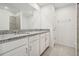 Clean, modern bathroom featuring a granite countertop, tiled shower, and neutral finishes at 3507 Salvia Ct, Tavares, FL 32778