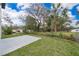 Green backyard with a concrete patio and lush foliage at 39 N Sunset Dr, Casselberry, FL 32707