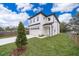 New two-story home features a two-car garage, manicured lawn, and modern architectural design at 39 N Sunset Dr, Casselberry, FL 32707