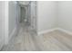 Bright hallway with wood floors leading to multiple rooms at 39 N Sunset Dr, Casselberry, FL 32707