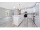 Modern kitchen with a center island, stainless steel appliances, and wood floors at 39 N Sunset Dr, Casselberry, FL 32707