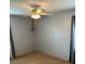 A bedroom featuring neutral carpet, a ceiling fan with lighting, and curtains by the window at 40201 Jericho Trl, Eustis, FL 32736