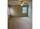 Bedroom with neutral carpet, a ceiling fan, and a window offering natural light at 40201 Jericho Trl, Eustis, FL 32736