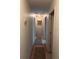 Hallway featuring hardwood floors, neutral walls and decorative rugs at 40201 Jericho Trl, Eustis, FL 32736