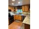 Well-lit kitchen featuring stainless steel appliances, granite countertops, and wooden cabinetry at 40201 Jericho Trl, Eustis, FL 32736