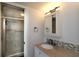 Bathroom featuring granite countertops, a sink and faucet, with a tiled shower in the background at 4117 Fairview Vista Pt # 105, Orlando, FL 32804