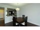 A stylish light fixture hangs over the dining room table with a pass-through view into the renovated kitchen at 4117 Fairview Vista Pt # 105, Orlando, FL 32804