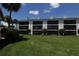 Exterior view of condo with screened lanai overlooking a manicured lawn on a clear day at 4117 Fairview Vista Pt # 105, Orlando, FL 32804