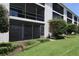 Ground-level view of lanai with checkerboard tile floor and screen, with a landscaped lawn at 4117 Fairview Vista Pt # 105, Orlando, FL 32804