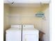 Laundry room including washer, dryer, and shelving for storage space at 4117 Fairview Vista Pt # 105, Orlando, FL 32804