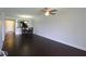 Bright open floorplan living room and dining area with dark wood flooring and neutral wall color at 4117 Fairview Vista Pt # 105, Orlando, FL 32804