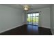 Bright living room featuring dark wood floors and a sliding glass door leading to the screened-in porch at 4117 Fairview Vista Pt # 105, Orlando, FL 32804