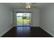 Bright living room featuring dark wood floors and a sliding glass door leading to the screened-in porch at 4117 Fairview Vista Pt # 105, Orlando, FL 32804