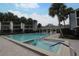 Community pool with a large pool deck, covered pavilion, hot tub and lush palm trees at 4117 Fairview Vista Pt # 105, Orlando, FL 32804