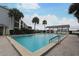 Community pool with a large pool deck, covered pavilion and lush tropical landscaping at 4117 Fairview Vista Pt # 105, Orlando, FL 32804