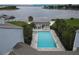 Overhead shot of a community pool with lake views, a bar area, and palm trees on a bright day at 4117 Fairview Vista Pt # 105, Orlando, FL 32804