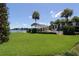 Community pool area and gazebo overlook a serene lake with mature palms in a well-maintained lawn at 4117 Fairview Vista Pt # 105, Orlando, FL 32804