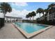 Community pool with a large pool deck, covered pavilion and lush palm trees at 4117 Fairview Vista Pt # 105, Orlando, FL 32804