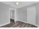 Bedroom featuring hardwood floors, closet, ceiling fan and an open doorway at 4228 Lenox Blvd, Orlando, FL 32811