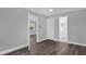 Light-filled bedroom with hardwood floors with open doors showing the bathroom and hall at 4228 Lenox Blvd, Orlando, FL 32811