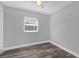 Comfortable bedroom with neutral walls, hardwood floors, and a window at 4228 Lenox Blvd, Orlando, FL 32811