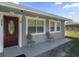 Inviting front porch with a classic door and decorative chairs, perfect for relaxing and enjoying the outdoors at 4228 Lenox Blvd, Orlando, FL 32811