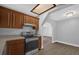 Kitchen with stainless steel oven, wood cabinets, and a connecting view to the living room at 4228 Lenox Blvd, Orlando, FL 32811