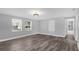 Bright living room featuring hardwood floors, modern lighting, and fresh gray walls at 4228 Lenox Blvd, Orlando, FL 32811