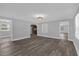 Inviting living room with hardwood floors seamlessly transitioning into the kitchen area at 4228 Lenox Blvd, Orlando, FL 32811