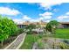 Serene backyard featuring lush landscaping, stone pathway, screened-in porch and a tranquil seating area at 4416 Flagg St, Orlando, FL 32812