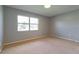 Bedroom featuring a large window offering neighborhood views and neutral carpet at 4416 Flagg St, Orlando, FL 32812