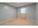 Cozy bedroom featuring a neutral carpet, and a large window providing ample natural light at 4416 Flagg St, Orlando, FL 32812