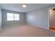 This bedroom features neutral carpet, light gray walls, one window, and a light at 4416 Flagg St, Orlando, FL 32812