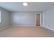 Neutral bedroom with neutral carpet, light gray walls, and a door to another room at 4416 Flagg St, Orlando, FL 32812