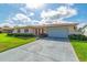 Charming single-story home with a manicured lawn, tidy landscaping, and a convenient two-car garage at 4416 Flagg St, Orlando, FL 32812