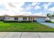 Charming single-story home with a manicured lawn, tidy landscaping, and a convenient two-car garage at 4416 Flagg St, Orlando, FL 32812