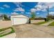 View of the detached two-car garage with concrete driveway and a well-maintained lawn at 4416 Flagg St, Orlando, FL 32812