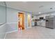 Updated kitchen featuring white cabinets, stainless steel appliances, and tile flooring at 4416 Flagg St, Orlando, FL 32812