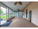 Enclosed sunroom with multiple windows, ceiling fans, neutral carpet, and access to the backyard at 4416 Flagg St, Orlando, FL 32812