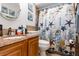 Full bathroom with a tub and shower combo, wood vanity, and nautical-themed shower curtain at 445 Autumn Oaks Pl, Lake Mary, FL 32746