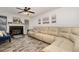 Spacious living room with a large sectional sofa, fireplace, and wood-look floors at 445 Autumn Oaks Pl, Lake Mary, FL 32746