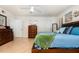 Well-lit main bedroom featuring a large bed and neutral tile flooring at 445 Autumn Oaks Pl, Lake Mary, FL 32746