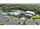 Aerial view showcases the community clubhouse and its various amenities, including pools and parking at 4759 Cloister St, Kissimmee, FL 34758