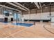 Large indoor gym featuring basketball courts, bleacher seating, volleyball nets, and natural light from tall windows at 4759 Cloister St, Kissimmee, FL 34758